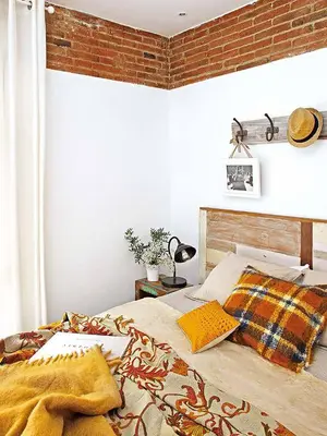 a bedroom with a bed and a brick wall at Charming Parallel in Barcelona