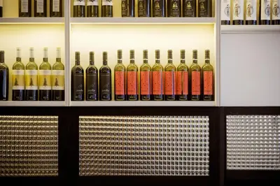 a bunch of bottles of wine on a shelf at Praktik Vinoteca in Barcelona