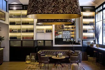 a bar with a leather couch and a table and chairs at Praktik Vinoteca in Barcelona
