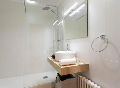 a bathroom with a sink and a mirror at Great Eixample Apartment in Barcelona