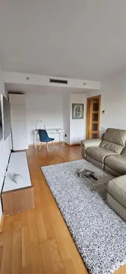 a living room with a couch and a table at Magnífica Isla de la playa Fórum y CCIB in Sant Adria de Besos