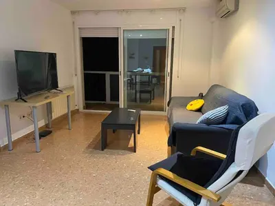 a living room with a couch and a television at Big Family Terrassa Parking and noise free in Terrassa