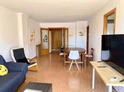a living room with a blue couch and a table at Big Family Terrassa Parking and noise free in Terrassa