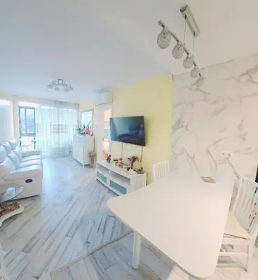 a living room with a white marble wall at Sweet home in Sant Adria de Besos