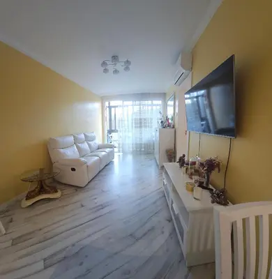 a living room with a white couch and a flat screen tv at Sweet home in Sant Adria de Besos