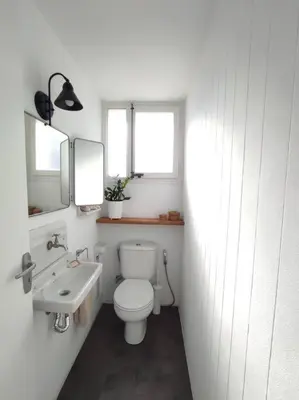 a white bathroom with a toilet and a sink at Casa Can Bellavista Barcelona town house in Premia de Dalt