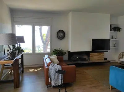 a living room with a couch and a tv at Casa Can Bellavista Barcelona town house in Premia de Dalt