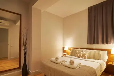 a bedroom with a large bed with towels on it at Catalan Comfort near Sagrada Familia by MyRentalHost in Barcelona