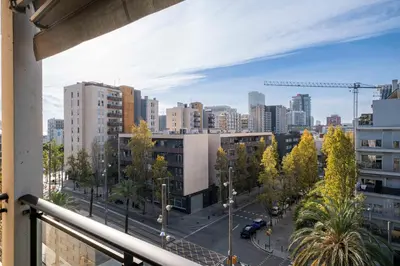 a view from a balcony of a city with buildings at Apartment close to Diagonal Beach in Barcelona