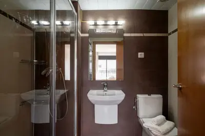a bathroom with a toilet and a sink and a shower at Apartment close to Diagonal Beach in Barcelona