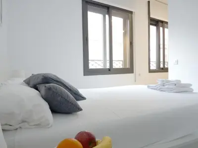 a bedroom with a bed with fruit on it at MarBarcelona Apartments Mas in Hospitalet de Llobregat