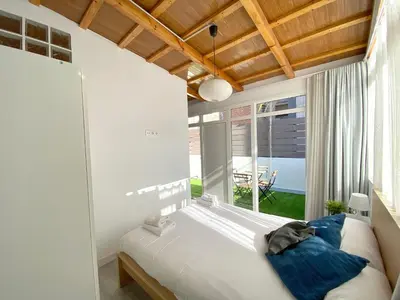 a bedroom with a large bed and a large window at MarBarcelona Apartments Mas in Hospitalet de Llobregat