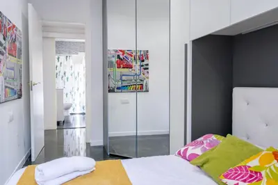 a bedroom with a bed and a mirror in it at VILLA 5 PLAYA A 2 MINUTOS in Castelldefels
