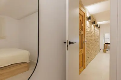 a mirror in a room with a bed and a bedroom at Stylish Apartment near Plaça España in Barcelona