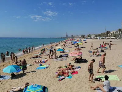 a large group of people on a beach at Apartamento P1 30min Sagrada Familia, 10 min playa in Badalona