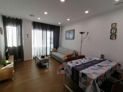a living room with a bed and a couch at Apartamento P1 30min Sagrada Familia, 10 min playa in Badalona