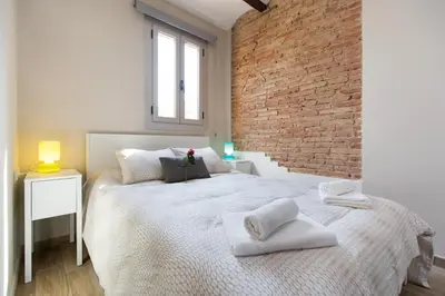 a bedroom with a large bed with towels on it at Stay Barcelona Charming Gracia in Barcelona
