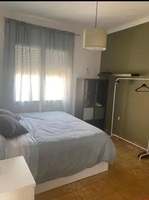 a bedroom with a bed and a window at Cozy apartament in Barcelona