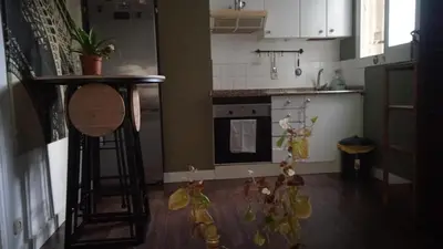 a kitchen with a counter and some figurines on the floor at Cozy apartament in Barcelona