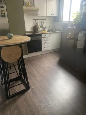 a kitchen with a counter and a table in it at Cozy apartament in Barcelona