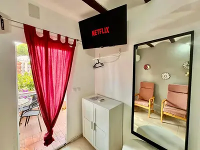 a room with a mirror and a red curtain at Nuevos Apartamentos frente al mar y a la playa in Castelldefels