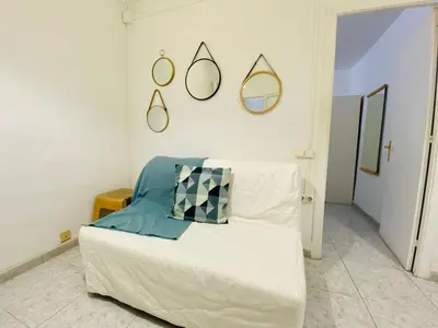 a bedroom with a white bed with mirrors on the wall at 017 New of love 3 1 in Barcelona