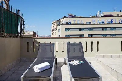 two benches on the roof of a building at AB Paral·lel Spacious Apartments in Barcelona