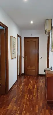 an empty room with wooden floors and doors at MAGNÍFICA RESIDENCIA in Masnou