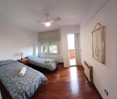a bedroom with two beds and a ceiling fan at MAGNÍFICA RESIDENCIA in Masnou