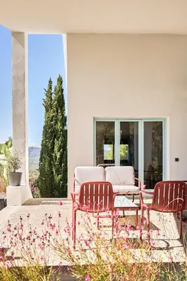 a patio with two chairs and a couch on a house at Casa Brisa Boutique Guest House - Gay Men Only in Sant Pere de Ribes