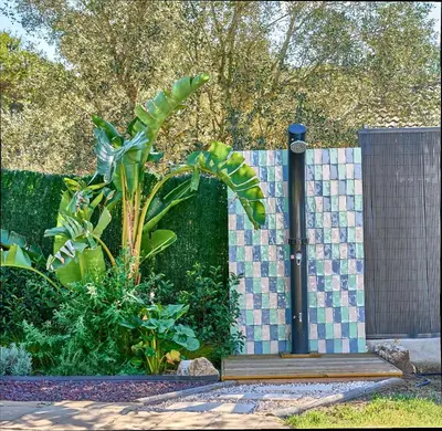 a fence with a plant next to a wooden platform at Casa Brisa Boutique Guest House - Gay Men Only in Sant Pere de Ribes