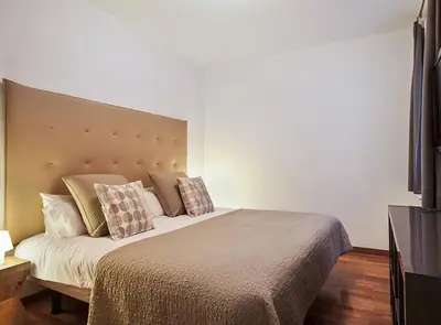 a bedroom with a large bed with pillows on it at Canela Homes BARCELONA UNIVERSITAT in Barcelona