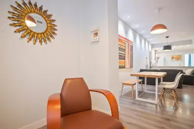 a living room with a chair and a table at Barcelona Eixample in Barcelona