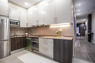 a kitchen with white cabinets and stainless steel appliances at Tendency Apartments 9 in Barcelona