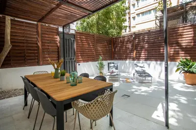 a wooden table and chairs on a patio at Tendency Apartments 9 in Barcelona