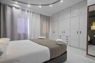 a bedroom with a large bed with white cabinets at Apartment Marti in Barcelona