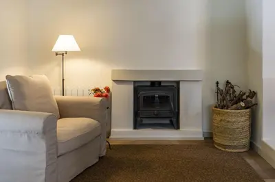 a living room with a couch and a fireplace at Finca Can Romeu: alojamiento rural entre viñedos in Font-Rubí