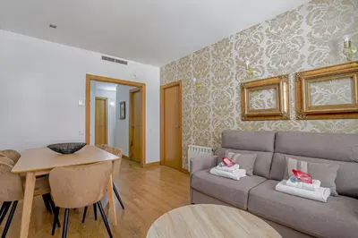 a living room with a couch and a table at Alcam Gold in Barcelona