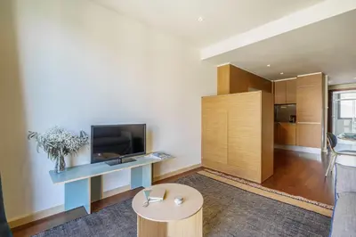 a living room with a table and a tv at Aspasios Diagonal Art Apartments in Barcelona