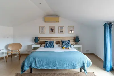 a bedroom with a bed with a blue blanket at AB Besòs River Apartment in Sant Adria de Besos