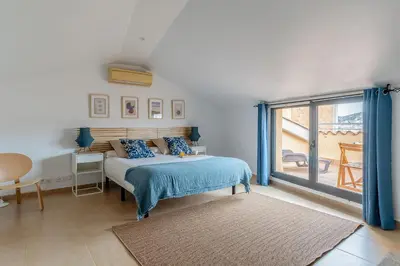 a bedroom with a bed and a large window at AB Besòs River Apartment in Sant Adria de Besos