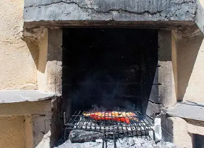 a brick oven with food cooking in it at Tu Casa en Barcelona in Sant Cugat del Vallès