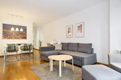 a living room with a couch and a table at Les Corts Exclusive Apartments by Olala Homes in Barcelona