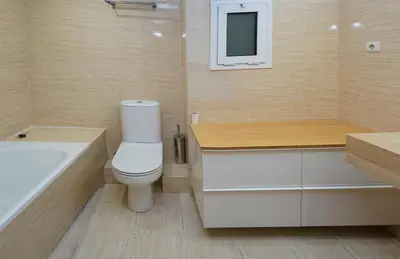 a bathroom with a toilet and a sink and a tub at MarBarcelona Suites Berlin in Barcelona