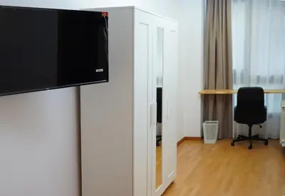 a room with a flat screen tv on a wall at MarBarcelona Suites Berlin in Barcelona