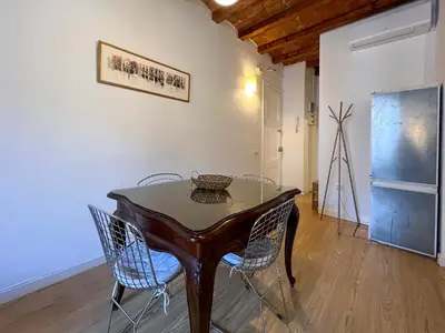 a dining room with a wooden table and chairs at Stay U-nique Apartment Arago II in Barcelona