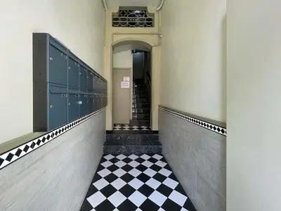 a hallway with a black and white checkered floor at Stay U-nique Apartment Arago II in Barcelona