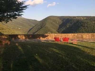 two red chairs sitting on top of a hill at Villa in Barcelona region stunning biosphere in El Brull