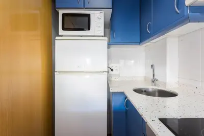 a kitchen with a white refrigerator and a microwave at The Best Barcelona in Barcelona
