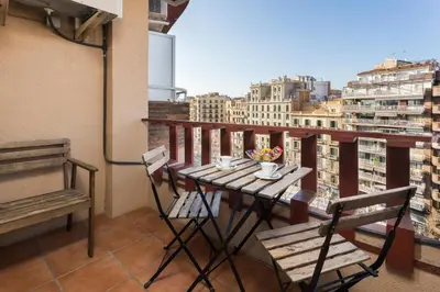 a table and chairs on a balcony with a view at The Best Barcelona in Barcelona